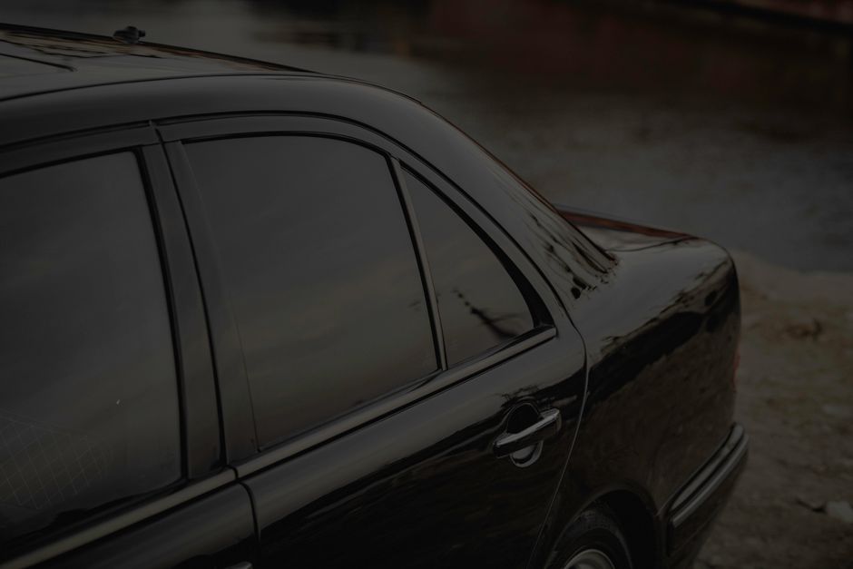 Professional window tinting film installation on large commercial windows in Houston