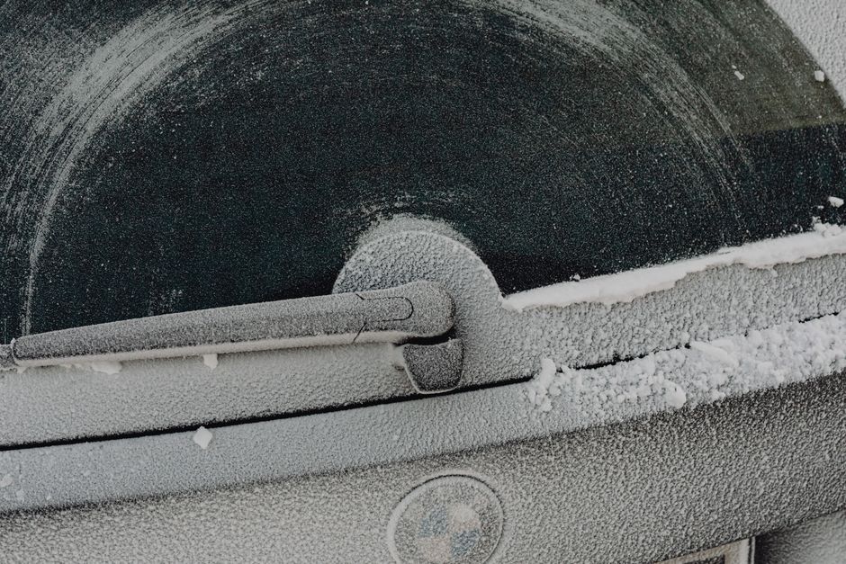 Frozen car windshield covered in ice and frost during a Texas cold snap